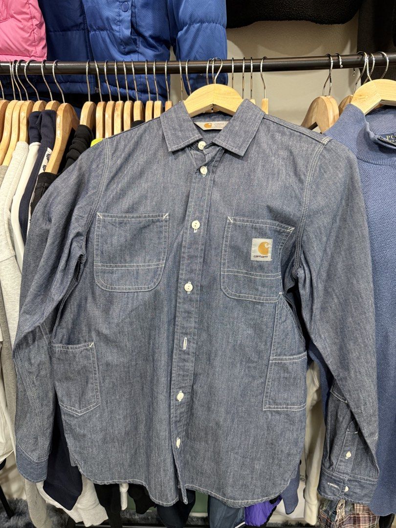 Carahartt Blue Denim Button-Down Work Shirt (Category: Coats, Jackets and Outerwear) located in Quezon City. Submitted by nichole12 (Listing ID 1467948577, Image 1). Description: - Brand: Carhartt - Color: Classic blue denim - Style: Button-down work shirt with structured collar - Details: White contrast stitching and iconic Carhartt logo patch on chest - Pockets: Two front chest pockets plus extra lower utility pockets - Sleeves: Long sleeves wi