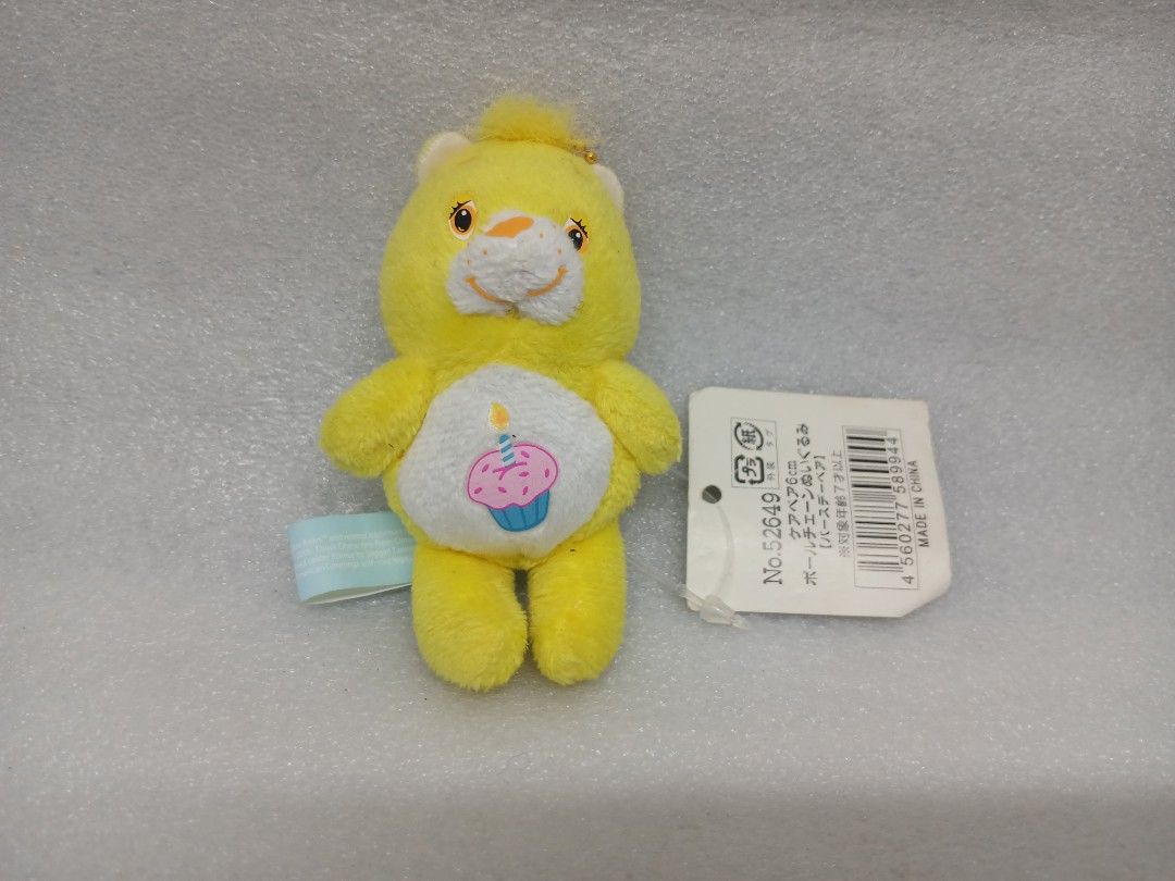 Care Bears Yellow Birthday Bear Plush Keychain (Category: Plushies & Soft Toys) located in Pila. Submitted by Yela.ph_1 (Listing ID 1467947457, Image 1). Description: - Authentic Yellow Care Bears plush keychain - Features a sweet pink cupcake belly symbol with a lit blue candle - Compact size: Measures approximately 6cm tall - Complete with original Japanese hang tag and blue tush tag - Includes a gold ball chain, ready to hang on your bag or ke