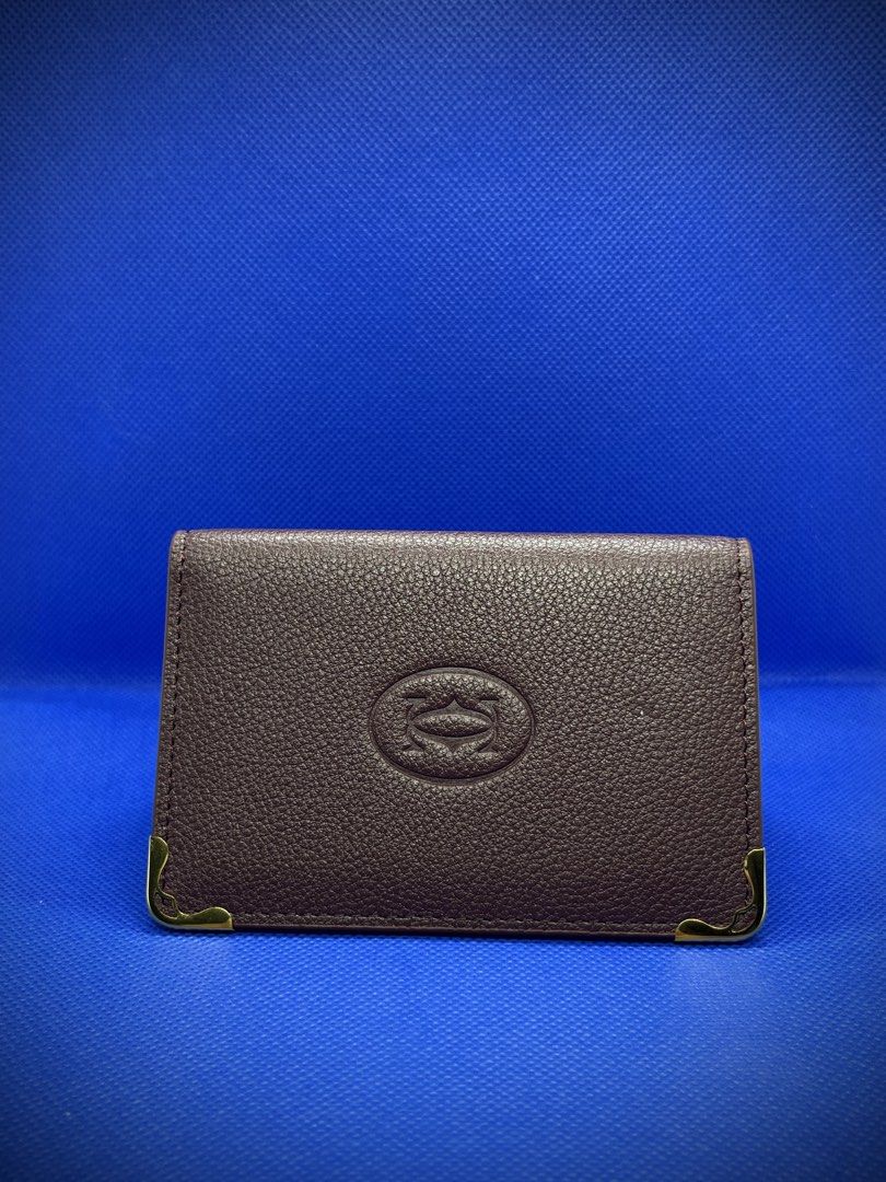 CARTIER MUST DE BI FOLD CARDHOLDER (Category: Wallets & Card Holders) located in Mandaluyong City. Submitted by sayso_says (Listing ID 1467994741, Image 2). Description: Cartier Must De Bi-fold Card Holder 🍷 Color: Wine Red / Burgundy 👜 Material: Calfskin Leather ✨ Condition: Excellent condition 📦 Inclusions: Cartier box, inner packaging, dust bag, booklet 🇸🇦 Purchased from: Saudi Arabia Cartier cardholder in a deep wine red/burgundy shade w