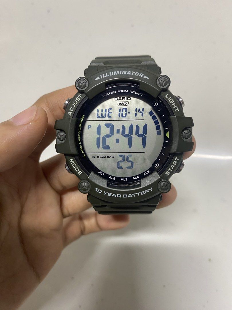 Casio AE-1500WH Digital Watch (Category: Women's Watches) located in Pasacao. Submitted by wengpullar37205 (Listing ID 1467890997, Image 1). Description: Casio AE-1500WH digital watch in olive green. Large round digital display with clear digits, day, and date. Resin strap, stainless steel back. Water resistant up to 100 meters. Built with a 10-year battery life, five alarms, and illuminator backlight. Buttons on both sides for adjusting time, li