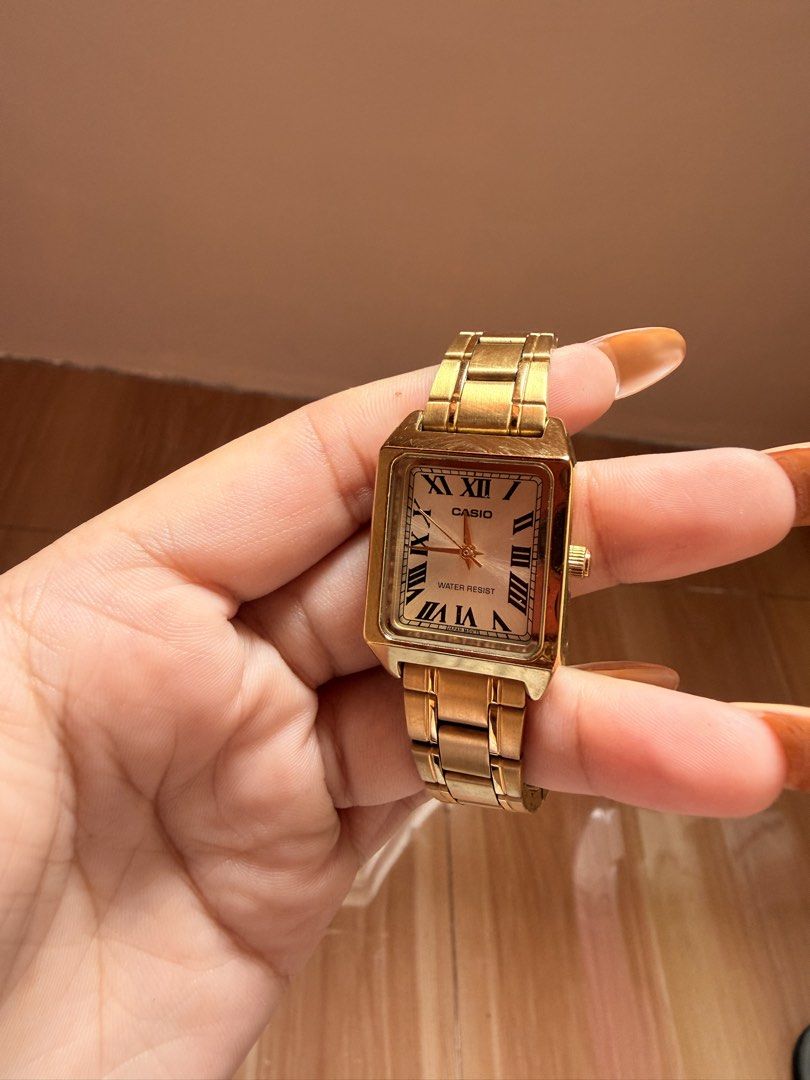 Casio LTP-V007 Gold Rectangular Roman Dial Watch (Category: Women's Watches) located in Makati City. Submitted by ja_cq (Listing ID 1467857801, Image 2). Description: -Authentic Casio Watch bought in Cash and Carry Makati,original price almost 5k plus - Brand/Model: Casio LTP-V007 Gold Tone Watch - Design: Vintage rectangular case with white dial and black Roman numerals - Materials: Stainless steel back and adjustable metal link bracelet with cl