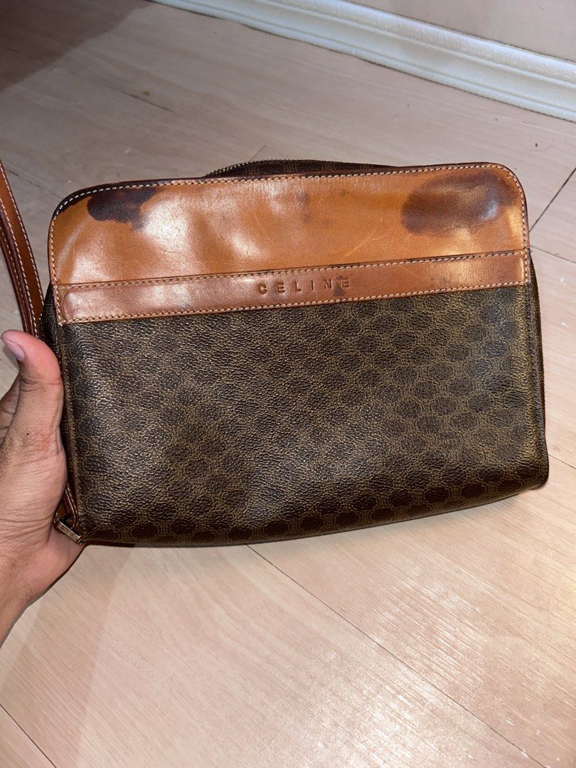 Celine Vintage Macadam Clutch bag (Category: Luxury Bags & Wallets) located in Dipolog. Submitted by adrian281994 (Listing ID 1467972334, Image 2). Description: - Brand: Celine - Material: Macadam and leather - Hardware: Gold-tone - Closure: Zipper - Inclusions: Removable leather wrist strap - Interior: Dark fabric lining with a slip pocket and stamped leather tag - Flaws: Discoloration and dark staining on the top leather flap section - Trusted 