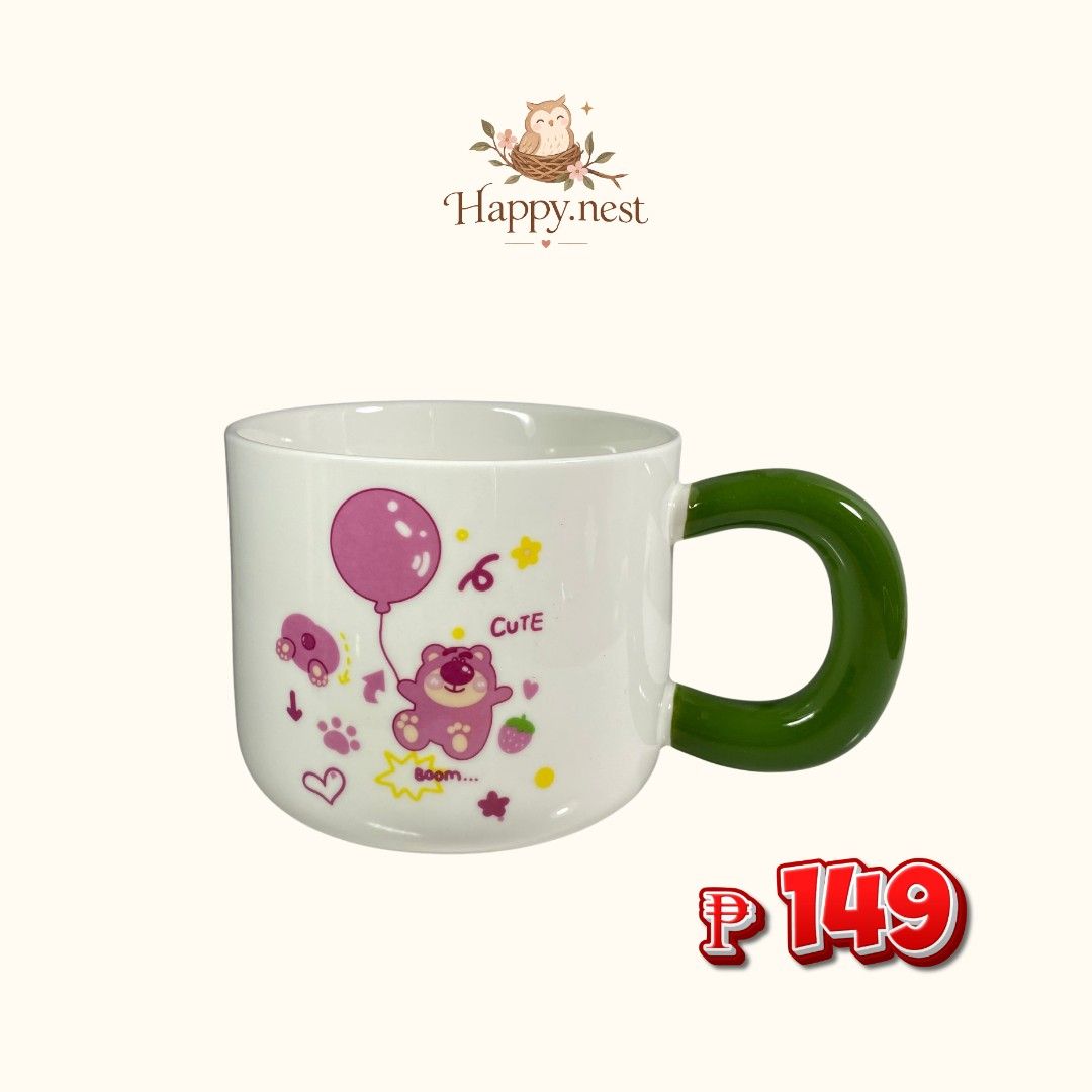 Ceramic Mug (Category: Coffee & Tea Tableware) located in Quezon City. Submitted by oliviararo46032 (Listing ID 1467994689, Image 1). Description: - White ceramic mug with cute pink bear, balloon, and strawberry graphic - Features a trendy chunky green handle - Microwave and dishwasher safe for easy daily use - Perfect for morning coffee, tea, or as a cute desk and kitchen decor - Brand new and ready to ship!.
