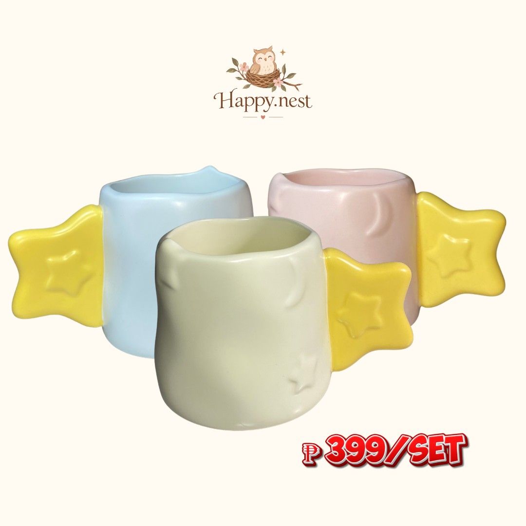 Ceramic Mugs Set of 3 (Category: Coffee & Tea Tableware) located in Quezon City. Submitted by oliviararo46032 (Listing ID 1467994460, Image 1). Description: - Brand: Happy.nest - Set of 3 pastel ceramic mugs (Light Blue, Soft Pink, Pale Yellow) - Features unique yellow star-shaped handles - Textured moon and star details on the body - Fun and colorful addition to any kitchen or coffee bar - Price: ₱399 for the set.