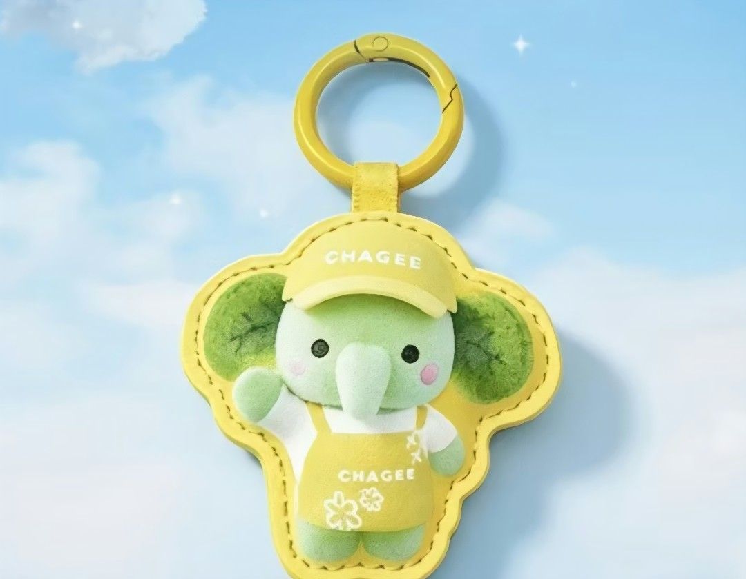 CHAGEE Baby Elephant Plush Keychain / Key Ring (Category: Other Merchandise) located in Pasig City. Submitted by swipeandpicks (Listing ID 1467995211, Image 3). Description: • Color: Pastel Mint Green (Elephant), Bright Lemon Yellow (Cap, Apron, Leather Frame, and Carabiner Clasp) • Material: Premium PU Leather (Outer protective frame and strap) + Soft Velveteen/Plush Fabric (Inner elephant doll) + Sturdy Zinc Alloy (Metal carabiner hook) •Size: 