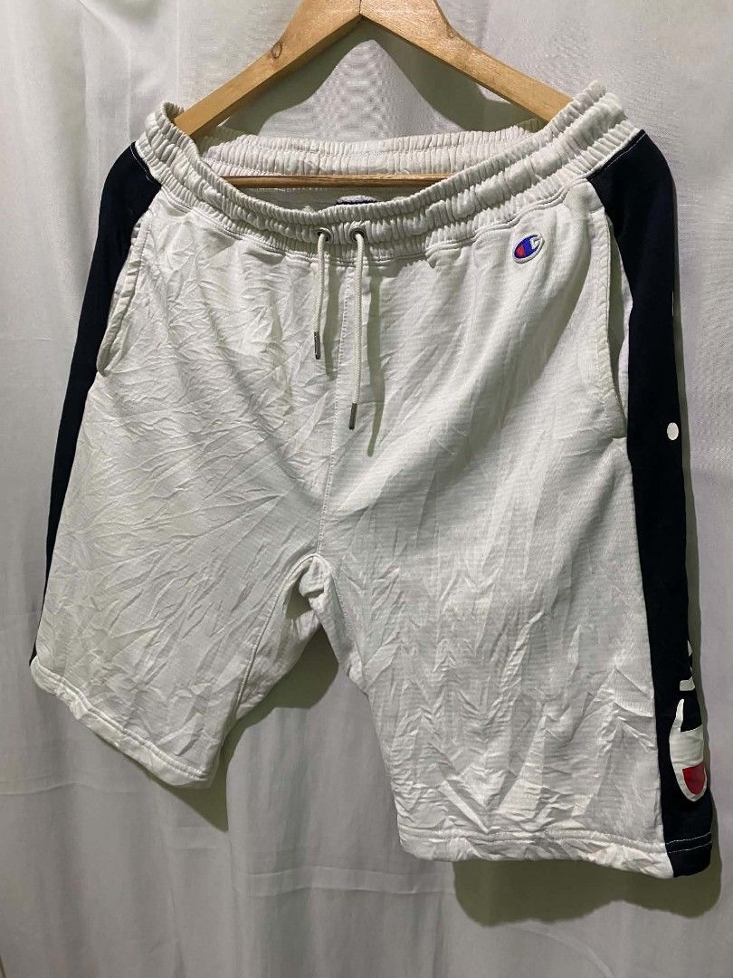 Champion White Side Stripe Sweatshorts (Category: Shorts) located in Quezon City. Submitted by elihur.tuazon (Listing ID 1467841448, Image 2). Description: - Color: White with dark blue side panels - Branding: Large Champion text logo on left leg and iconic embroidered C logo near pocket - Fit & Comfort: Elastic waistband with adjustable drawstring cords - Features: Two practical side pockets - Material: Breathable cotton blend - Ideal for: Casua