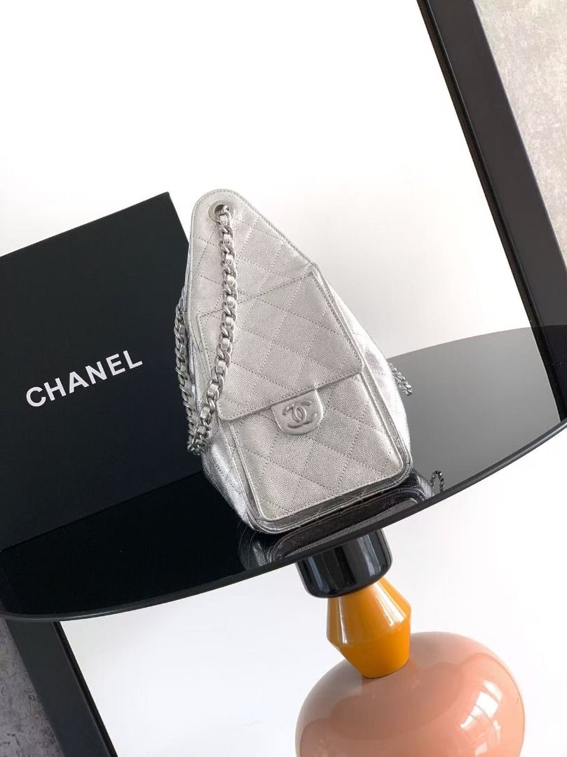 Chanel Silver Quilted Leather Drawstring Bucket Bag (Category: Luxury Bags & Wallets) located in Davao. Submitted by colacodawr20358 (Listing ID 1467930084, Image 2). Description: - Brand: Chanel - Style: Quilted Bucket Bag - Color: Metallic Silver with silver-tone hardware - Closure: Secure drawstring with iconic interlocking CC hardware and chain details - Exterior: Structured sides, front flap pockets with classic turnlock closures, crisp fini