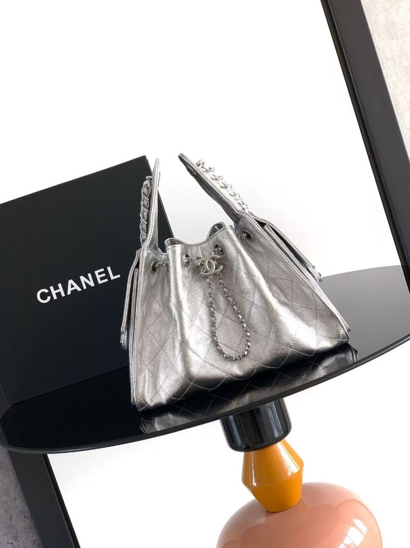 Chanel Silver Quilted Leather Drawstring Bucket Bag (Category: Luxury Bags & Wallets) located in Davao. Submitted by colacodawr20358 (Listing ID 1467930084, Image 1). Description: - Brand: Chanel - Style: Quilted Bucket Bag - Color: Metallic Silver with silver-tone hardware - Closure: Secure drawstring with iconic interlocking CC hardware and chain details - Exterior: Structured sides, front flap pockets with classic turnlock closures, crisp fini