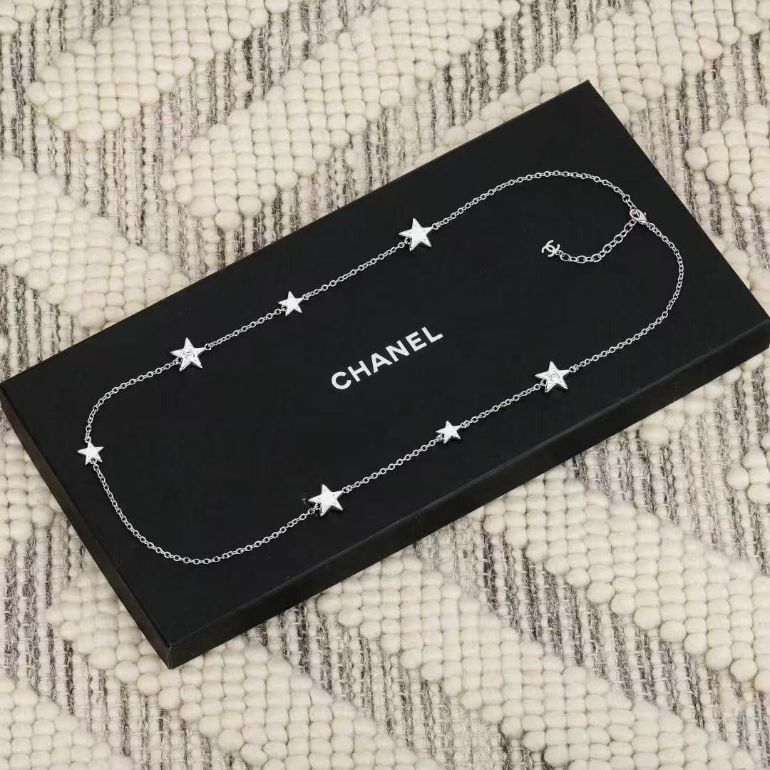 Chanel Silver Star Station Necklace (Category: Necklaces) located in Paranaque City. Submitted by emoemobern98221 (Listing ID 1467898669, Image 2). Description: - Brand: Chanel - Design: Silver-tone chain with multiple star charms - Details: Lobster clasp closure with iconic interlocking CC logo charm on the extender - Inclusion: Comes with original black Chanel gift box - Condition/Style: Delicate piece, ideal for daily wear or layering.