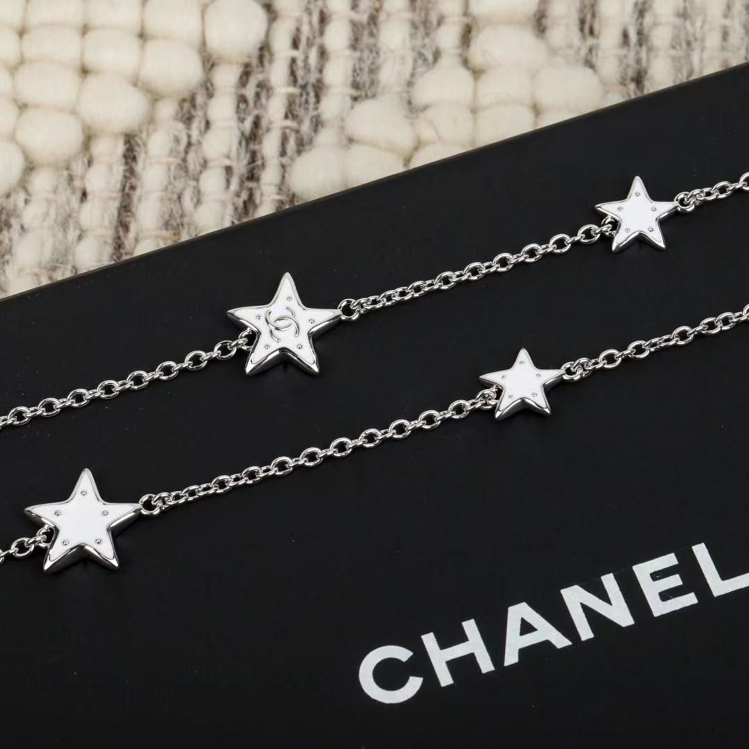 Chanel Silver Star Station Necklace (Category: Necklaces) located in Paranaque City. Submitted by emoemobern98221 (Listing ID 1467898669, Image 3). Description: - Brand: Chanel - Design: Silver-tone chain with multiple star charms - Details: Lobster clasp closure with iconic interlocking CC logo charm on the extender - Inclusion: Comes with original black Chanel gift box - Condition/Style: Delicate piece, ideal for daily wear or layering.