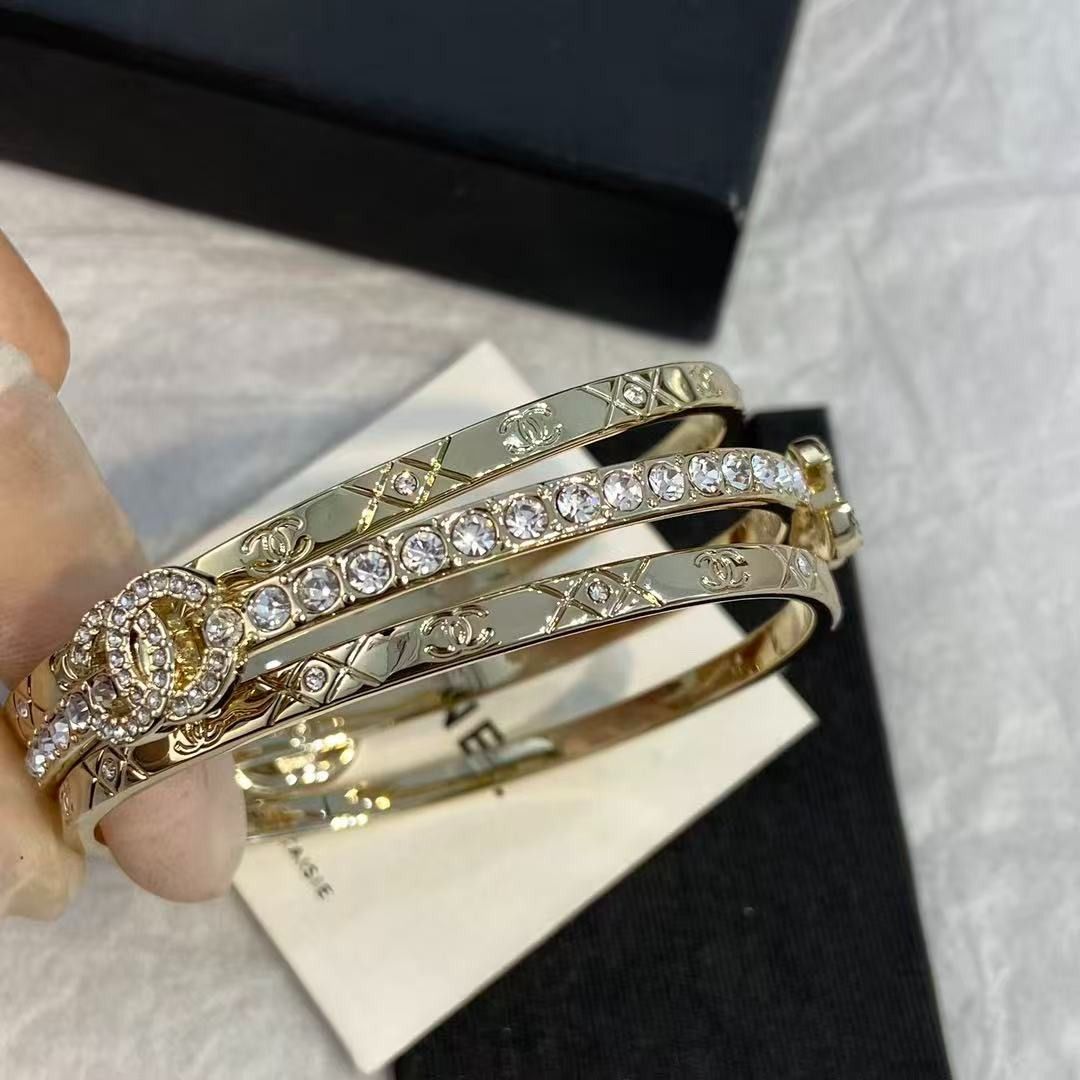 Chanel triple band crystal logo gold bangle set (Category: Bracelets) located in Las Pinas. Submitted by freemoon_7a5e73 (Listing ID 1467921832, Image 2). Description: - Authentic Chanel gold-tone triple bangle bracelet set - Features a sparkling crystal-lined middle band and quilted outer bands with CC logos - Interlocking crystal CC charm centerpiece - Rigid, hinge-free design with a satisfying heavy metal weight - Hallmarked inside the inner b