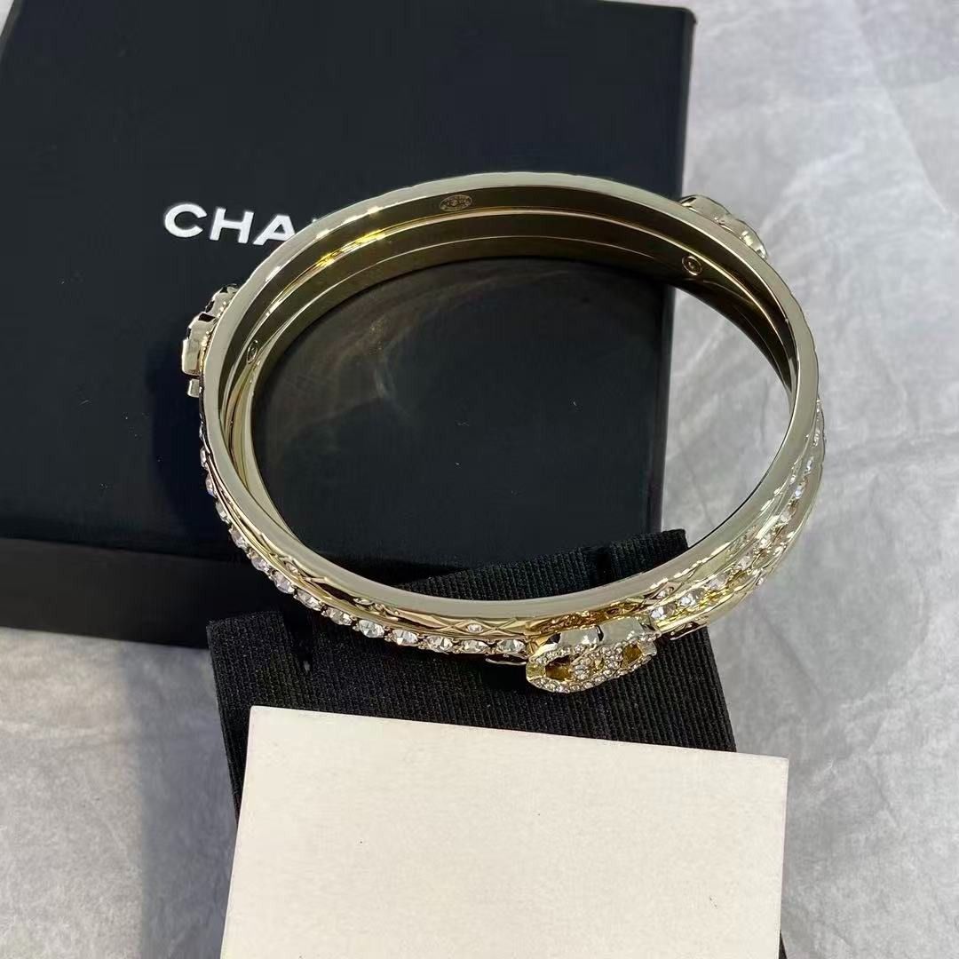 Chanel triple band crystal logo gold bangle set (Category: Bracelets) located in Las Pinas. Submitted by freemoon_7a5e73 (Listing ID 1467921832, Image 3). Description: - Authentic Chanel gold-tone triple bangle bracelet set - Features a sparkling crystal-lined middle band and quilted outer bands with CC logos - Interlocking crystal CC charm centerpiece - Rigid, hinge-free design with a satisfying heavy metal weight - Hallmarked inside the inner b