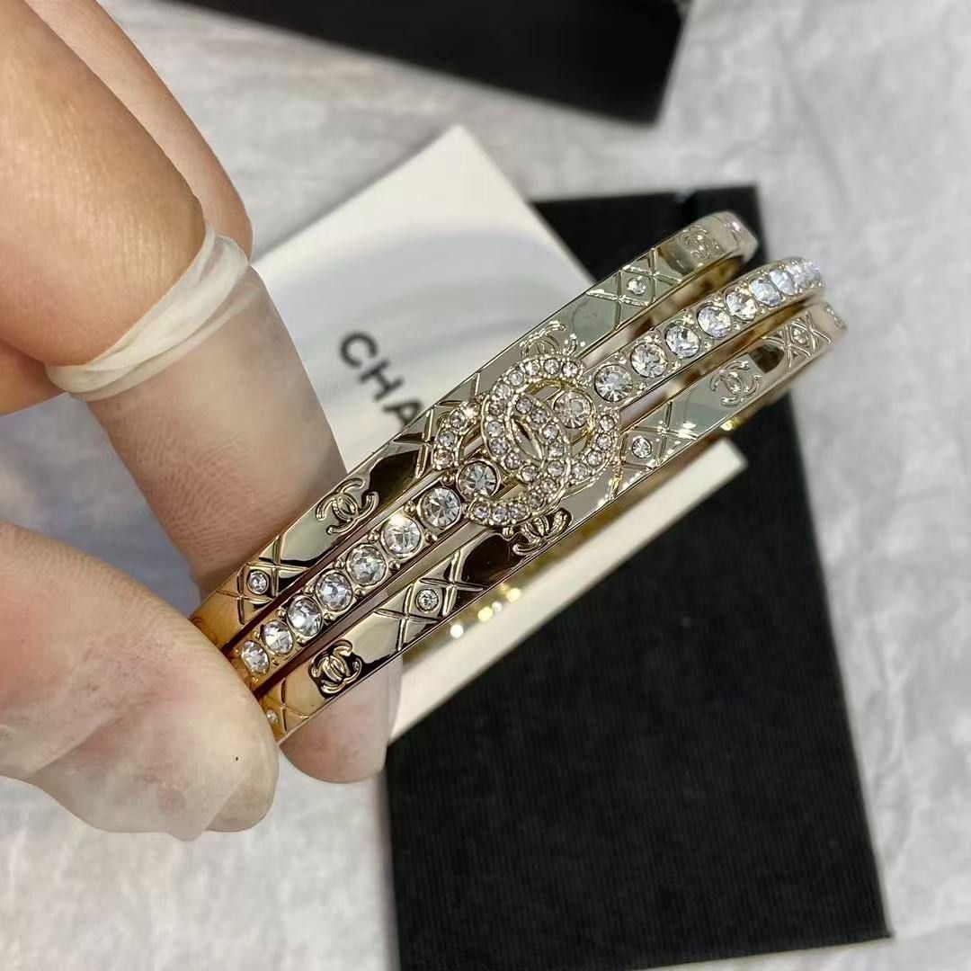 Chanel triple band crystal logo gold bangle set (Category: Bracelets) located in Las Pinas. Submitted by freemoon_7a5e73 (Listing ID 1467921832, Image 1). Description: - Authentic Chanel gold-tone triple bangle bracelet set - Features a sparkling crystal-lined middle band and quilted outer bands with CC logos - Interlocking crystal CC charm centerpiece - Rigid, hinge-free design with a satisfying heavy metal weight - Hallmarked inside the inner b