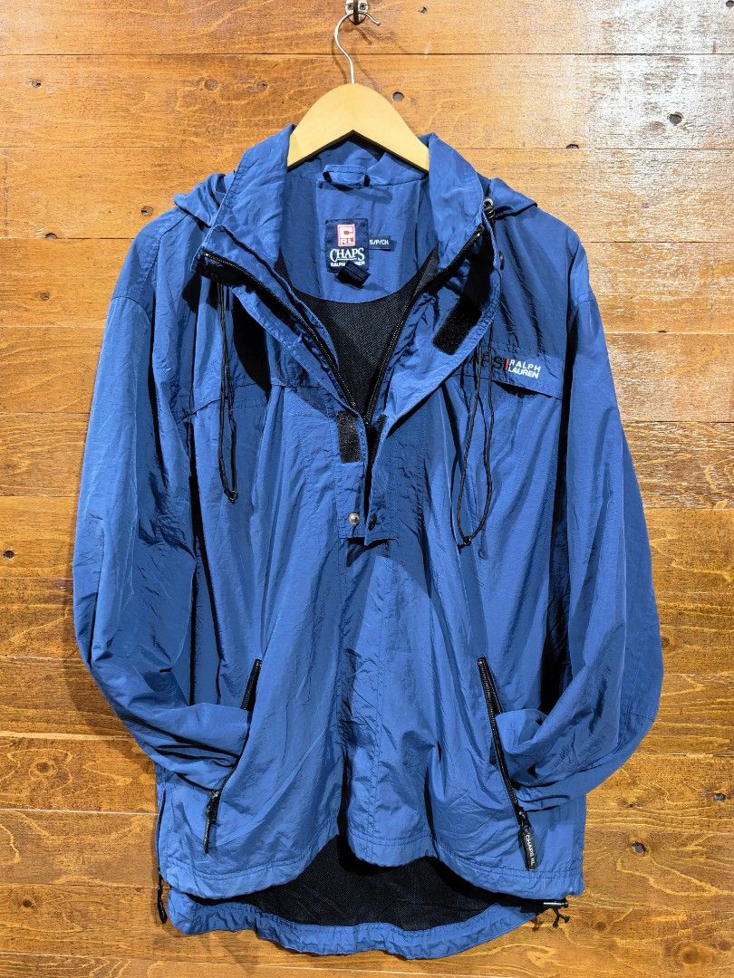 Chaps Ralph Lauren Blue Anorak Windbreaker Jacket (Category: Coats, Jackets and Outerwear) located in Paranaque City. Submitted by caboodlespremium (Listing ID 1468003942, Image 2). Description: Dimes: L-27in W- 17in Chaps Ralph Lauren anorak windbreaker jacket in blue. Half zip front with snap button placket and adjustable hood drawstrings. Embroidered logo on the chest. Dual zippered front pockets. Mesh lining inside. Elastic cuffs and adjustab