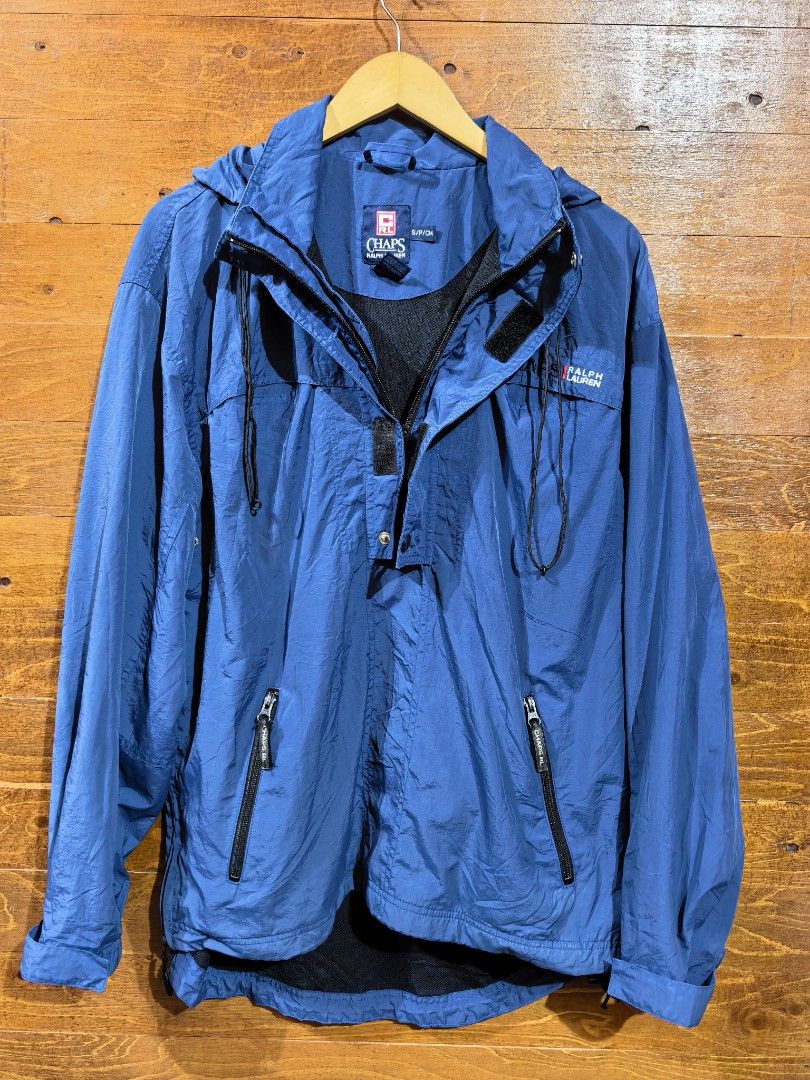 Chaps Ralph Lauren Blue Anorak Windbreaker Jacket (Category: Coats, Jackets and Outerwear) located in Paranaque City. Submitted by caboodlespremium (Listing ID 1468003942, Image 3). Description: Dimes: L-27in W- 17in Chaps Ralph Lauren anorak windbreaker jacket in blue. Half zip front with snap button placket and adjustable hood drawstrings. Embroidered logo on the chest. Dual zippered front pockets. Mesh lining inside. Elastic cuffs and adjustab