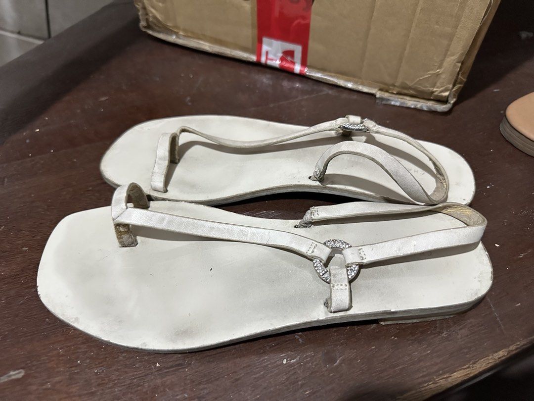 Charles & Keith White Sandals (Category: Flats & Sandals) located in Manila. Submitted by shopkriscloset (Listing ID 1467841657, Image 2). Description: Needs cleaning/whitening :) Issues: minimal cracks/peelings on the leather. Can send more photos upon request ‼️PLEASE READ BEFORE PLACING AN OFFER -Please be patient and respectful. 🤗 If I don’t get to reply immediately, I might be working. - Please REFRAIN from making an offer if you do not int