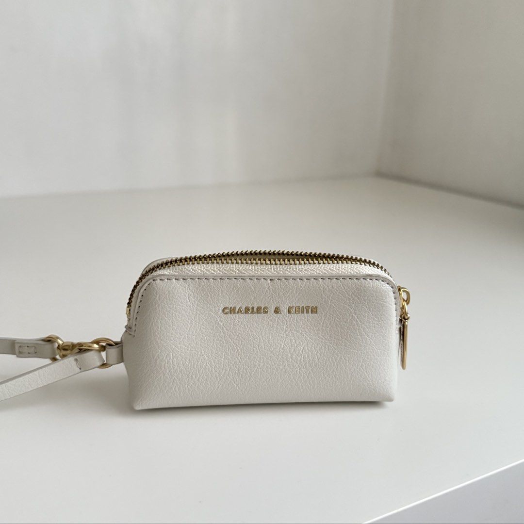 Charles & Keith Wristlet/Coin Purse (Category: Cross-body Bags) located in Quezon City. Submitted by 0ffTheRack (Listing ID 1467888619, Image 1). Description: - Gold hardware - Detachable wrist strap and clasp - Excellent condition - No scratches on hardware - Clean interior and exterior.