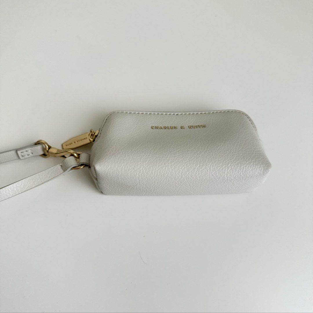 Charles & Keith Wristlet/Coin Purse (Category: Cross-body Bags) located in Quezon City. Submitted by 0ffTheRack (Listing ID 1467888619, Image 3). Description: - Gold hardware - Detachable wrist strap and clasp - Excellent condition - No scratches on hardware - Clean interior and exterior.