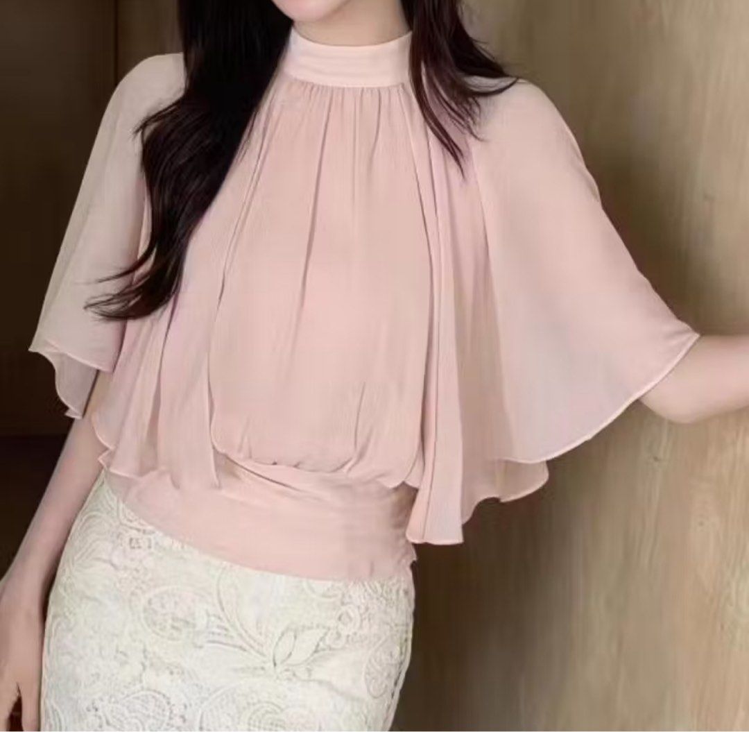 Chiffon Cape Sleeve Mock Neck Pink Blouse (Category: Blouses) located in Manila. Submitted by soundofcheollie (Listing ID 1467906357, Image 2). Description: Pink chiffon blouse with layered cape sleeves and mock neckline. Fitted cinched waist detail. Soft pastel color works great for casual outings or café dates. Lightweight flowy fabric. size: S .