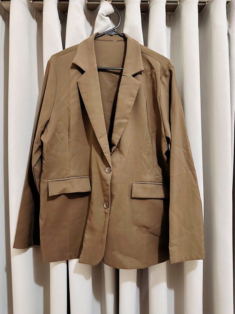 Choco Brown / Khaki oversized Blazer fits XL (Category: Coats, Jackets and Outerwear) located in Quezon City. Submitted by mananglinette (Listing ID 1467175119, Image 1). Description: - Color: Khaki choco Brown - Style: Classic lapel collar with two-button closure - Features: Long sleeves and two deep functional front pockets with flaps - Material: Smooth, high-quality fabric - Versatility: Easy to style for both office wear and casual outings - 