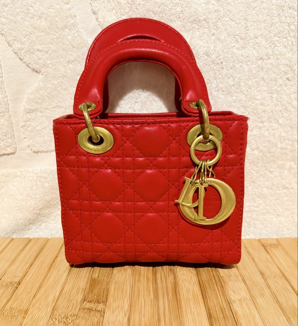 Christian Dior Lady Dior Red Handbag (Category: Luxury Bags & Wallets) located in Caloocan City. Submitted by shnicky101 (Listing ID 1468000876, Image 1). Description: DIOR Mini Lady Dior (Red Cannage Lambskin) Details & Condition: Classic red Cannage quilted lambskin with pale gold-tone D.I.O.R. charms. Good preloved condition overall; minor peeling on back handle (shown in photos). Gifted item (no receipt) .