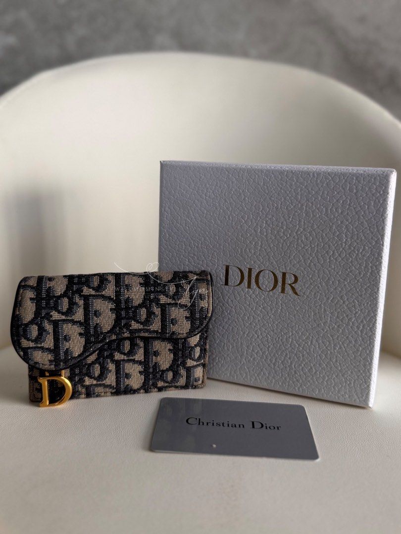 Christian Dior Saddle Wallet Oblique Jacquard (Category: Luxury Bags & Wallets) located in Bacoor. Submitted by iammommylyn (Listing ID 1467916452, Image 2). Description: - Brand: Christian Dior - Style: Saddle Bifold Wallet - Material: Blue Oblique Jacquard Canvas with Blue Leather Trim - Hardware: Antique Gold-Finish D Stirrup - Inclusions: Original Dior Presentation Box - Condition: Excellent, compact size perfect for everyday use and small ba