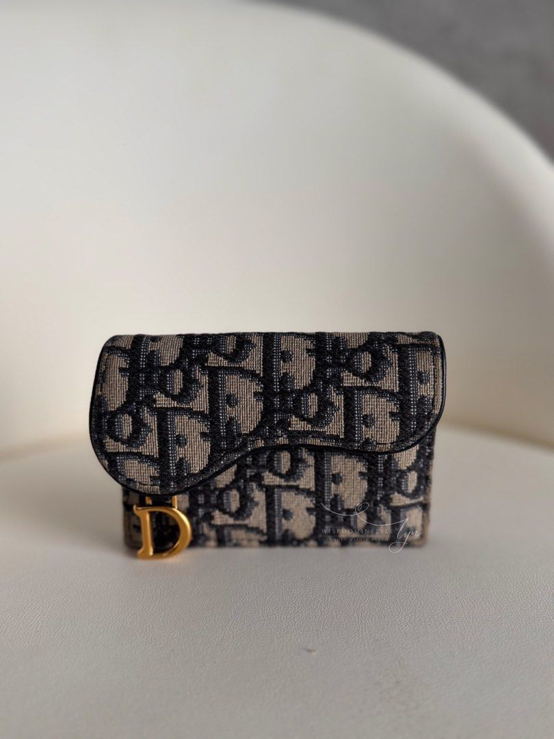 Christian Dior Saddle Wallet Oblique Jacquard (Category: Luxury Bags & Wallets) located in Bacoor. Submitted by iammommylyn (Listing ID 1467916452, Image 3). Description: - Brand: Christian Dior - Style: Saddle Bifold Wallet - Material: Blue Oblique Jacquard Canvas with Blue Leather Trim - Hardware: Antique Gold-Finish D Stirrup - Inclusions: Original Dior Presentation Box - Condition: Excellent, compact size perfect for everyday use and small ba