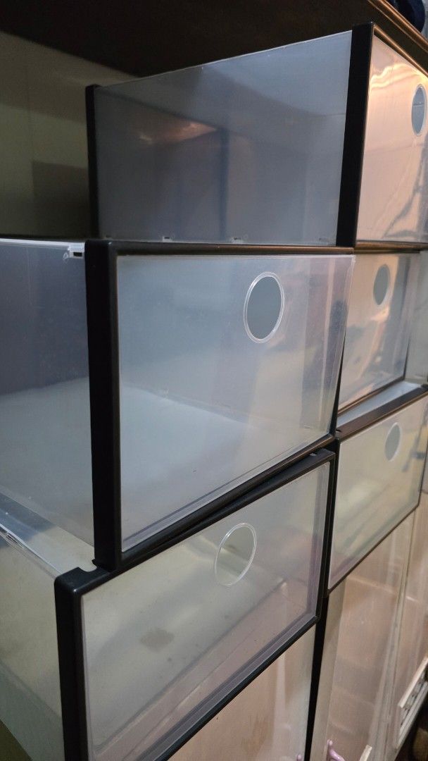 Clear stackable plastic shoe storage boxes organizer (Category: Storage Boxes & Baskets) located in Manila. Submitted by deeejybee (Listing ID 1467933830, Image 2). Description: - Clear plastic storage boxes with sleek black frames - Convenient drop-front doors for easy access - Built-in ventilation holes on front panels - Stackable and sturdy design to maximize space - Perfect for organizing shoes, bags, or accessories - Easy to assemble, clean,