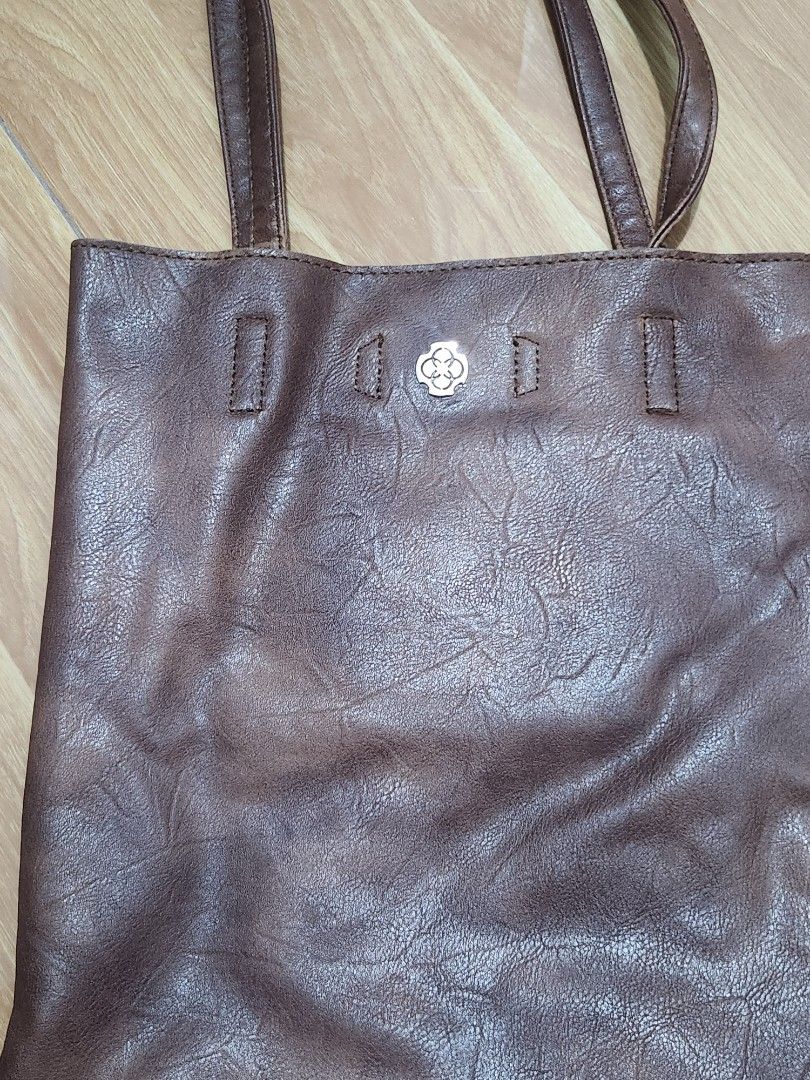 CLN Leather Tote Bag (Category: Tote Bags) located in Binan City. Submitted by prettyfishcakeee (Listing ID 1467977703, Image 2). Description: - Material: Soft crinkled brown leather with stylish silver metal hardware plaque - Straps: Comfortable double shoulder straps for easy carrying - Storage: Spacious main compartment with plenty of room for daily essentials, books, or a tablet - Organization: Convenient zippered inner pocket to keep smaller