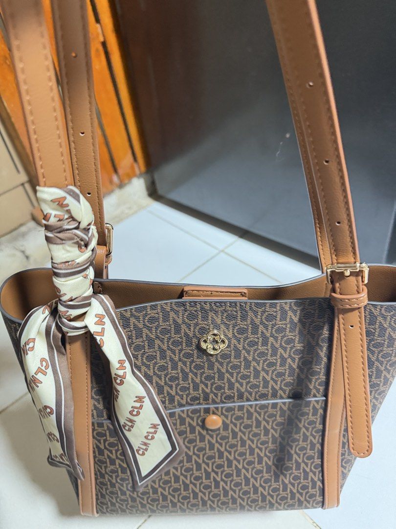 CLN Monogram Tote Bag with Scarf Accent (Category: Tote Bags) located in Las Pinas. Submitted by sugaaarr (Listing ID 1467862357, Image 3). Description: - Brand: CLN - Color: Brown and tan monogram - Design: Durable structured shoulder bag - Straps: Dual straps with adjustable buckles - Pockets: Front slip pocket with button accent - Hardware: Elegant gold-tone details - Inclusion: Matching patterned twill scarf tied on the handle.