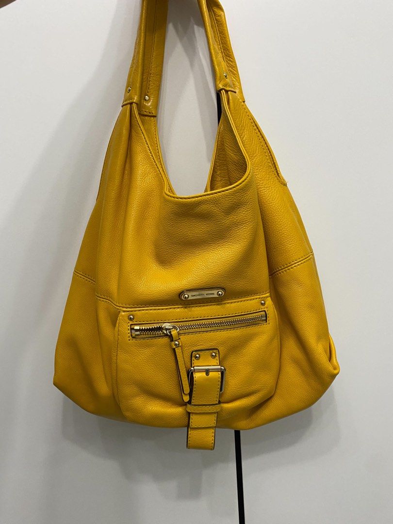 Coach and MK bags (Category: Luxury Bags & Wallets) located in Manila. Submitted by nienieniee (Listing ID 1468049005, Image 2). Description: - Coach orange leather bag - MK yellow mustard shoulder bag - Coach peach and black color way handbag All are in good condition and no major flaw!! Rfs: Decluttering.