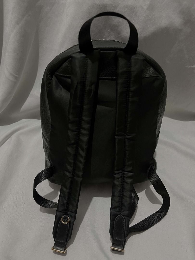 Coach Backpack (Category: Backpacks) located in Caloocan City. Submitted by gellaease (Listing ID 1467931657, Image 3). Description: - Color: Sleek black - Material: Textured leather and durable nylon panels - Comfort: Padded shoulder straps with adjustable nylon webbing - Features: Secure top carry handle and two-way zipper closure - Style: Clean stitching, minimalist design, easy to match with any outfit.