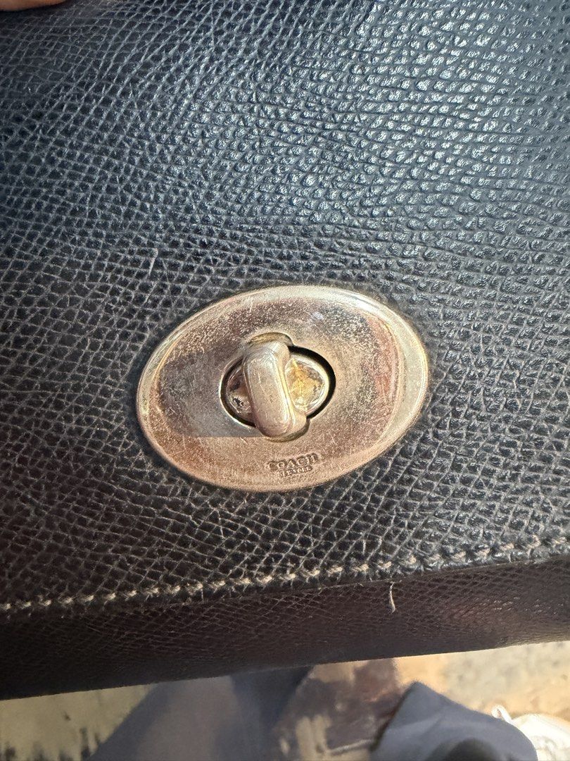 Coach Black Leather Turnlock Handbag (Category: Luxury Bags & Wallets) located in Manila. Submitted by kayecake_ (Listing ID 1467862384, Image 2). Description: - Brand: Coach - Material: Premium black textured leather - Hardware: Silver-tone with classic turnlock front closure - Interior: Spacious main compartment with back slip pocket and gold-stamped storypatch - Design: Structured silhouette with clean stitching - Condition: Well-maintained an