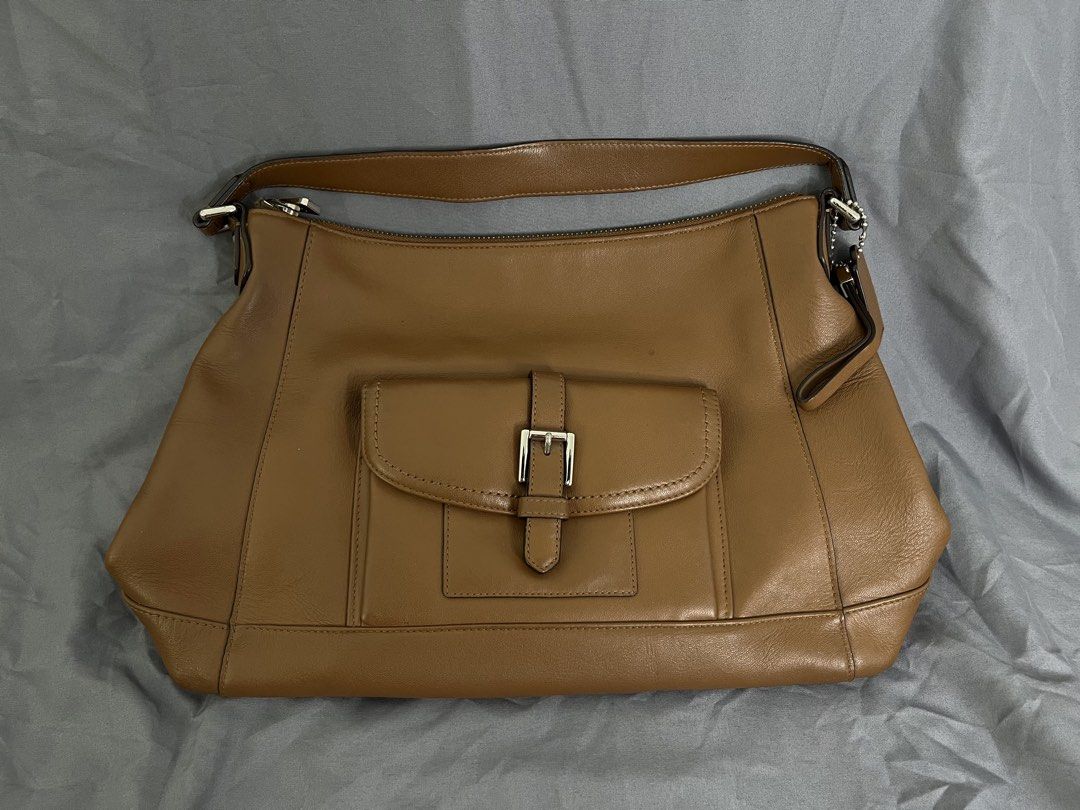 Coach Charlie Leather Hobo Bag (Category: Luxury Bags & Wallets) located in Imus. Submitted by graeyowl (Listing ID 1467943069, Image 2). Description: • Brand: Coach • Style: Charlie Leather Hobo (Style No. F29881) • Color: Tan / Saddle / British Tan • Hardware: Polished Silver-Tone • Material: Premium Glove-Tanned Leather.