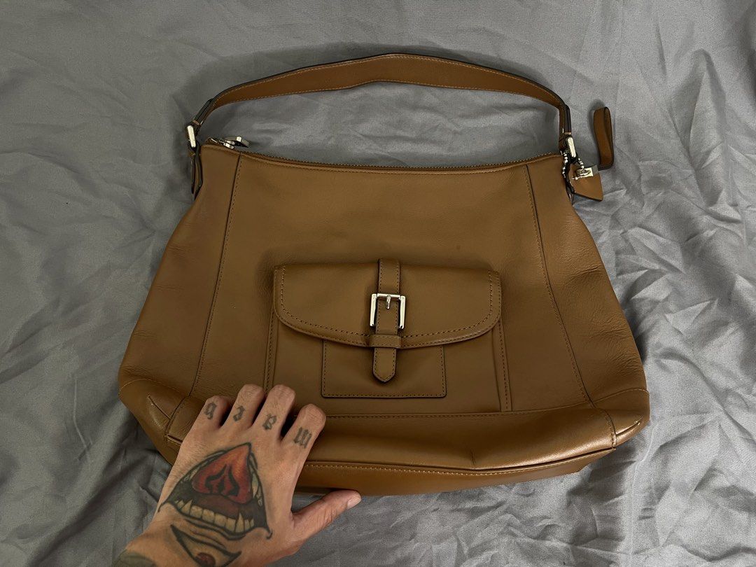 Coach Charlie Leather Hobo Bag (Category: Luxury Bags & Wallets) located in Imus. Submitted by graeyowl (Listing ID 1467943069, Image 1). Description: • Brand: Coach • Style: Charlie Leather Hobo (Style No. F29881) • Color: Tan / Saddle / British Tan • Hardware: Polished Silver-Tone • Material: Premium Glove-Tanned Leather.
