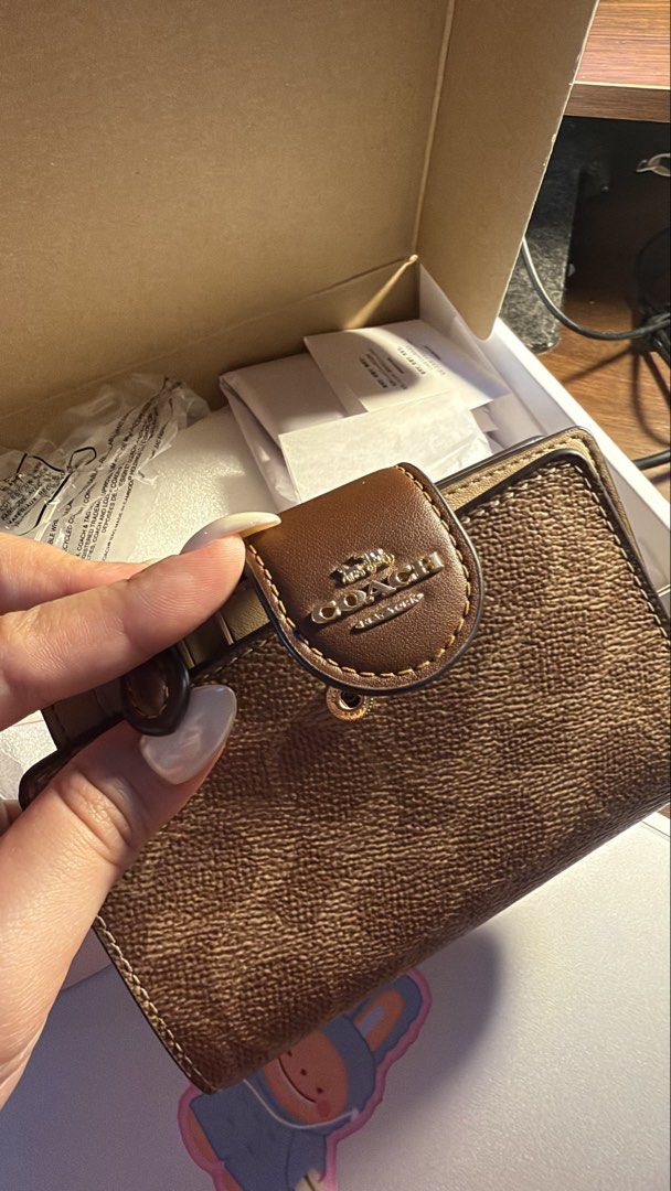 Coach Corner Zip Wallet Medium Signature In Tan (Category: Luxury Bags & Wallets) located in Pasig City. Submitted by usttiger (Listing ID 1467917856, Image 1). Description: Used for a year but in pristine condition. Comes with a box and looks fairly new. Gold Ensemble still shining and didn’t fade. SRP: ₱9,615 Selling for: ₱4,995 Brand: Coach - Condition: Unused with original box, packaging, and papers - Design: Classic brown signature monogram 