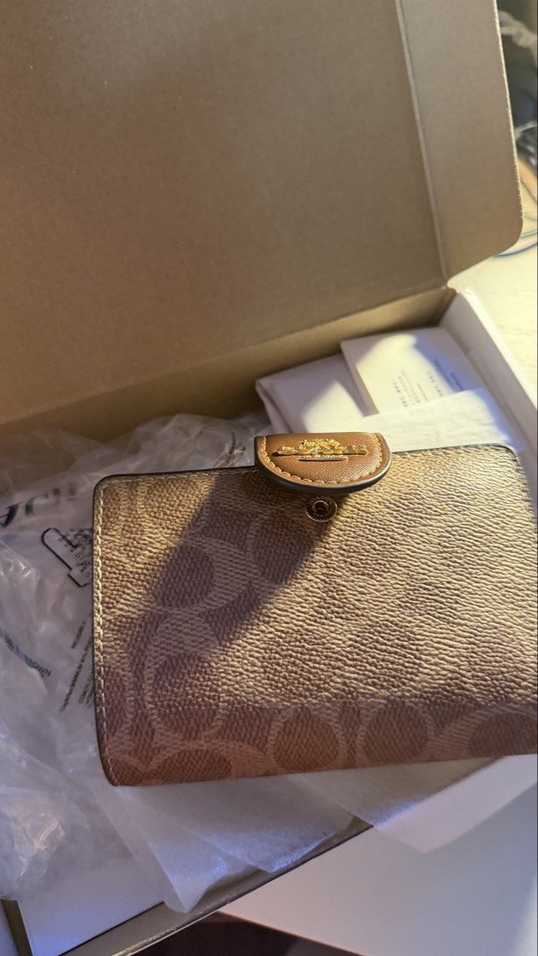 Coach Corner Zip Wallet Medium Signature In Tan (Category: Luxury Bags & Wallets) located in Pasig City. Submitted by usttiger (Listing ID 1467917856, Image 3). Description: Used for a year but in pristine condition. Comes with a box and looks fairly new. Gold Ensemble still shining and didn’t fade. SRP: ₱9,615 Selling for: ₱4,995 Brand: Coach - Condition: Unused with original box, packaging, and papers - Design: Classic brown signature monogram 