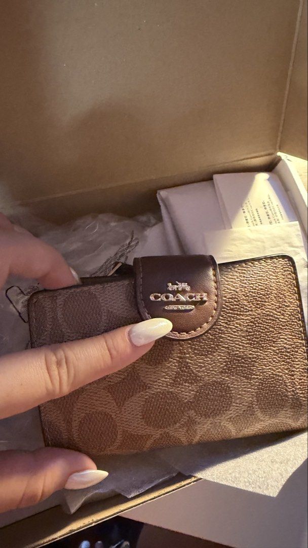 Coach Corner Zip Wallet Medium Signature In Tan (Category: Luxury Bags & Wallets) located in Pasig City. Submitted by usttiger (Listing ID 1467917856, Image 2). Description: Used for a year but in pristine condition. Comes with a box and looks fairly new. Gold Ensemble still shining and didn’t fade. SRP: ₱9,615 Selling for: ₱4,995 Brand: Coach - Condition: Unused with original box, packaging, and papers - Design: Classic brown signature monogram 
