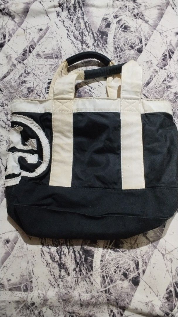 Coach Leatherware Floral Tote Bag (Category: Tote Bags) located in Davao. Submitted by jellisaiah.ocean (Listing ID 1468055035, Image 2). Description: - Brand: Coach - Material: White canvas with brown leather accents - Design: All-over floral pattern with front horse and carriage logo - Features: Spacious main compartment and double leather shoulder straps - Condition: Good, with minor signs of wear near handles and bottom corners - Perfect for 