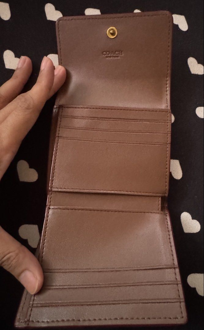 Coach Mila Small Flap Wallet (Category: Luxury Bags & Wallets) located in Quezon City. Submitted by minekoh21 (Listing ID 1467904178, Image 3). Description: - Brand: Coach - Style: Trifold wallet - Material: Leather - Color: Brown (standard Coach color) - Hardware: Gold-tone - Closure: Front snap with signature C logo - Exterior: Back zipper pocket for coins - Interior: Multiple card slots, cash compartment, and Coach New York embossed stamp Prod