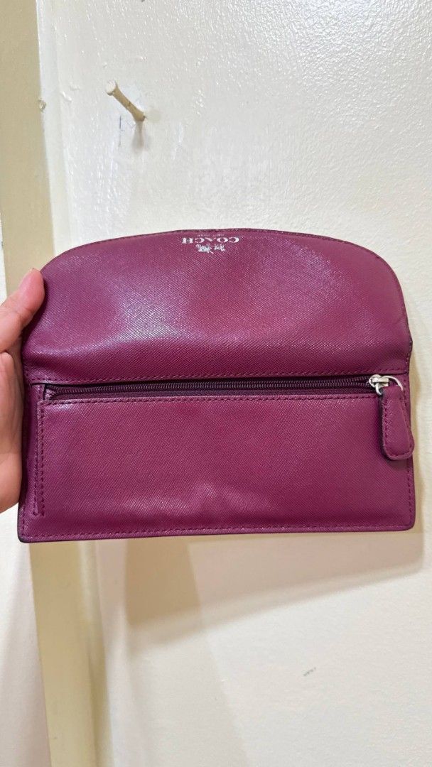 Coach Plum Saffiano Leather Wallet (Category: Wallets & Card holders) located in Lingayen. Submitted by eckkaaa213 (Listing ID 1467957476, Image 2). Description: ykk zip flaws in see pic maliit lang - Brand: Coach - Material: Durable crosshatch Saffiano leather - Color: Rich plum purple with silver-tone hardware - Closure: Secure front snap closure - Interior: Multiple card slots and a convenient zippered coin compartment - Condition: Clean insid