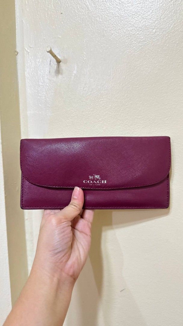 Coach Plum Saffiano Leather Wallet (Category: Wallets & Card holders) located in Lingayen. Submitted by eckkaaa213 (Listing ID 1467957476, Image 1). Description: ykk zip flaws in see pic maliit lang - Brand: Coach - Material: Durable crosshatch Saffiano leather - Color: Rich plum purple with silver-tone hardware - Closure: Secure front snap closure - Interior: Multiple card slots and a convenient zippered coin compartment - Condition: Clean insid