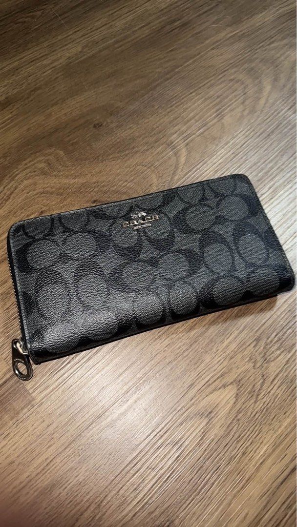 Coach Signature Black Zip Around Wallet (Category: Wallets & Card holders) located in Caloocan City. Submitted by bosstin8 (Listing ID 1467879369, Image 1). Description: - Authentic black Coach wallet featuring the classic C monogram pattern - Sturdy coated canvas construction for daily durability - Sleek silver-tone hardware and matching zipper pull - Secure zip-around closure keeps cards and cash safe - Clean exterior with a smooth, hassle-free