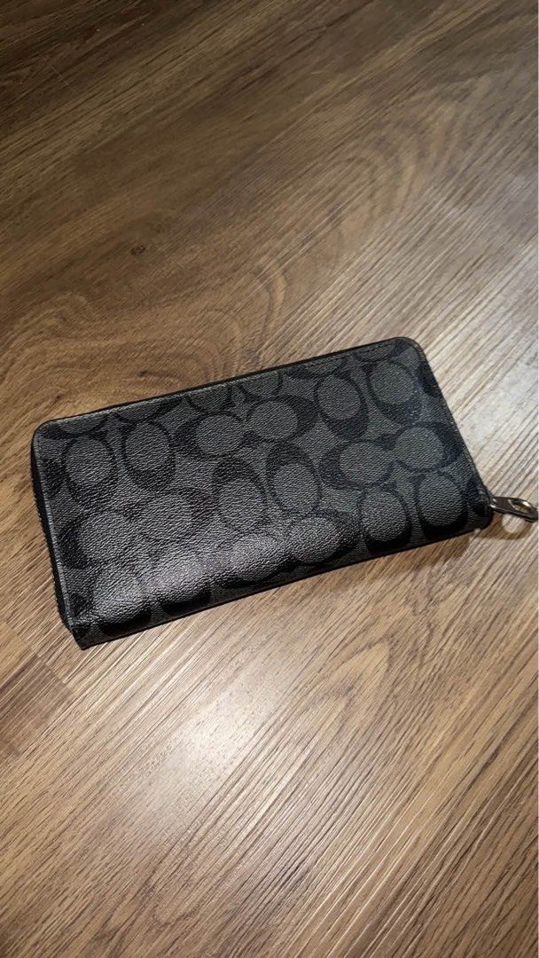 Coach Signature Black Zip Around Wallet (Category: Wallets & Card holders) located in Caloocan City. Submitted by bosstin8 (Listing ID 1467879369, Image 2). Description: - Authentic black Coach wallet featuring the classic C monogram pattern - Sturdy coated canvas construction for daily durability - Sleek silver-tone hardware and matching zipper pull - Secure zip-around closure keeps cards and cash safe - Clean exterior with a smooth, hassle-free