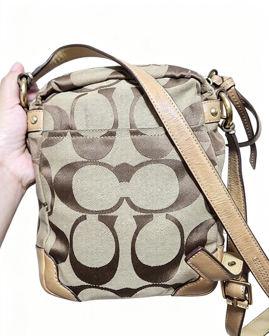 Coach Signature Canvas Crossbody Bag with Python Print (Category: Cross-body Bags) located in Manila. Submitted by jialyn03310_tree (Listing ID 1467835818, Image 2). Description: - Authentic Coach crossbody bag - Signature canvas with brown python embossed leather center panel - Gold-tone horse and carriage logo plaque - Tan leather trim on bottom corners and adjustable shoulder strap - Secure top zip closure - Accented with contrasting white str