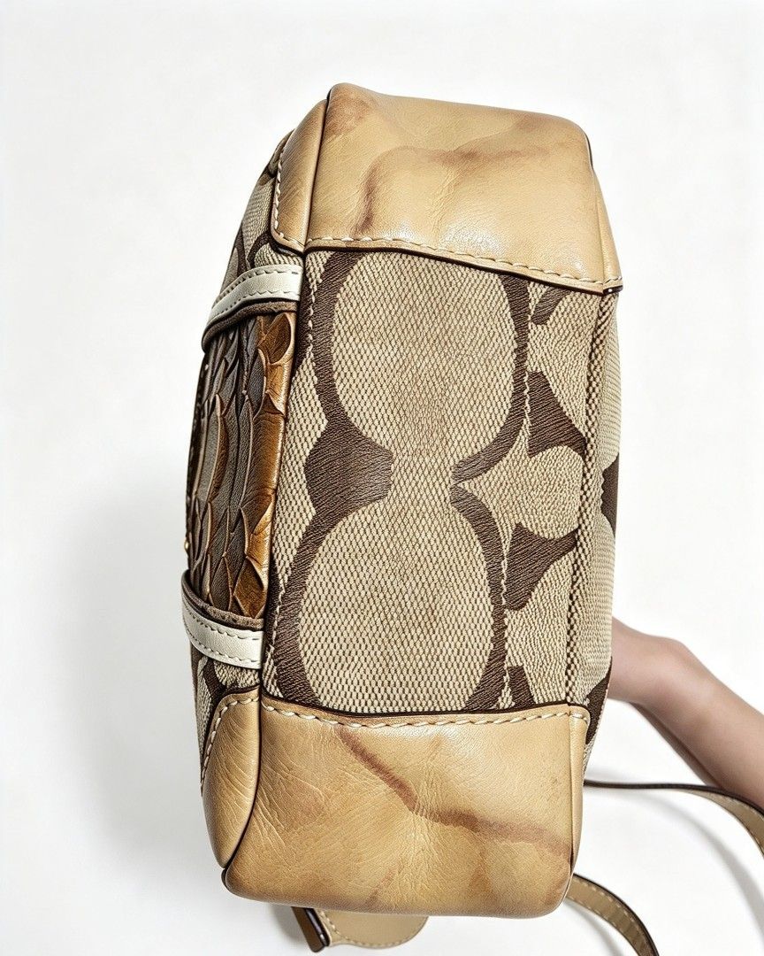 Coach Signature Canvas Crossbody Bag with Python Print (Category: Cross-body Bags) located in Manila. Submitted by jialyn03310_tree (Listing ID 1467835818, Image 3). Description: - Authentic Coach crossbody bag - Signature canvas with brown python embossed leather center panel - Gold-tone horse and carriage logo plaque - Tan leather trim on bottom corners and adjustable shoulder strap - Secure top zip closure - Accented with contrasting white str