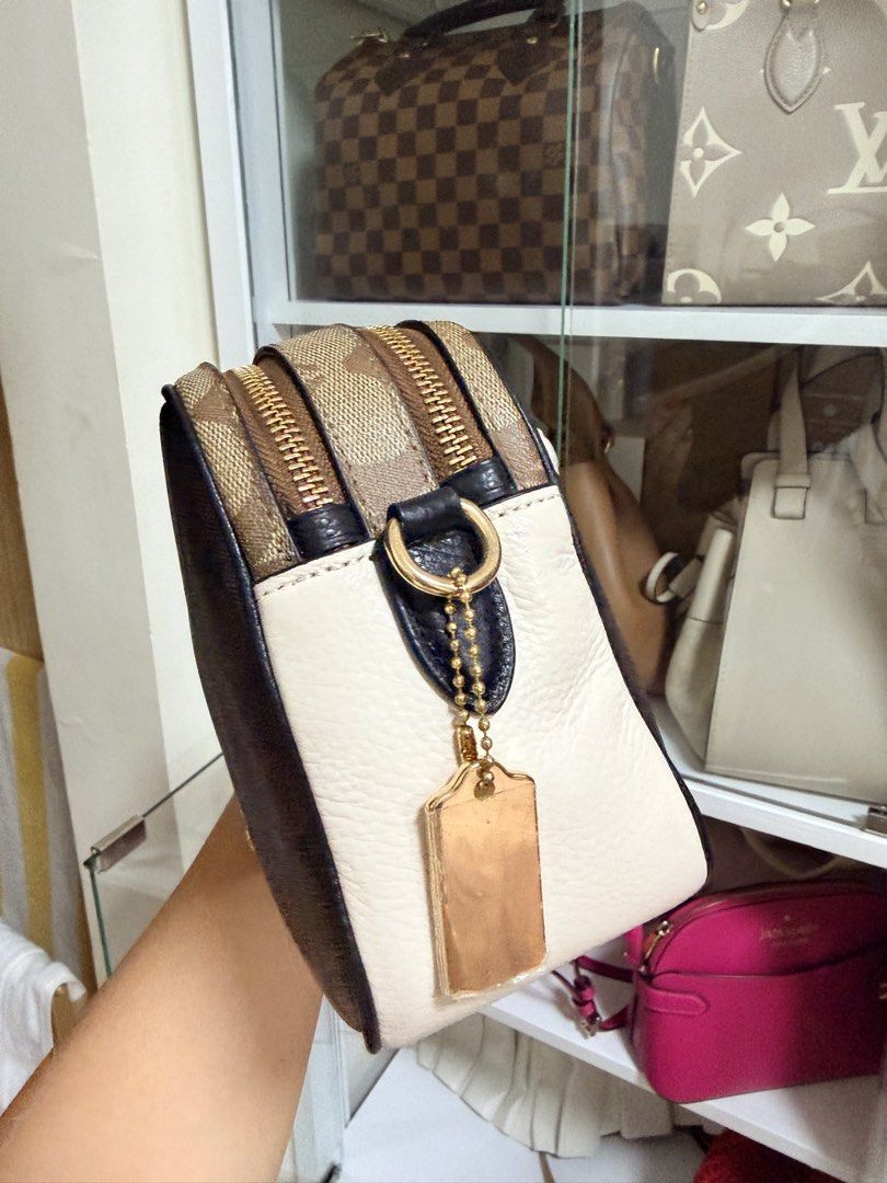 Coach Signature Canvas Double Zip Camera Bag (Category: Luxury Bags & Wallets) located in Manila. Submitted by carlajoyce (Listing ID 1468051090, Image 2). Description: - Authentic Coach camera bag - Dark brown signature monogram canvas with cream white leather trim - Dual zip compartments with elegant gold-tone hardware - Includes a detachable black leather strap for versatile styling - Comes with the iconic Coach hangtag - Perfect size for your