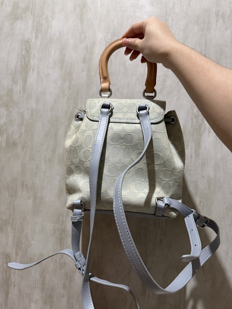 Coach Signature Jacquard Mini backpack with Top Handle (Category: Backpacks) located in Abucay. Submitted by fastlion.584bdf (Listing ID 1468023506, Image 2). Description: Coach mini backpack in light blue and beige signature jacquard fabric. Features a front pocket with a turnlock closure and leather hangtag. Tan leather top handle and adjustable grey straps. Drawstring closure under the main flap. Compact size, handy for daily essentials. Clean