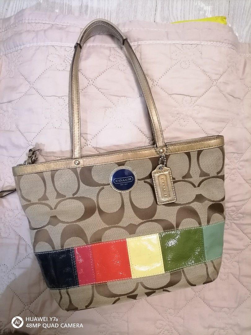 Coach Signature Stripe Patchwork Tote Bag (Category: Luxury Bags & Wallets) located in Naga. Submitted by mrwisethrifter (Listing ID 1467853458, Image 1). Description: - Brand: Coach - Material: Signature C jacquard fabric with colorful patent leather bottom - Trim/Handles: Gold metallic leather (shows light wear) - Interior: Blue fabric lining with creed patch (No. E1068-F15585) - Closure: Zipper top - Inclusion: Original Coach leather hangtag -