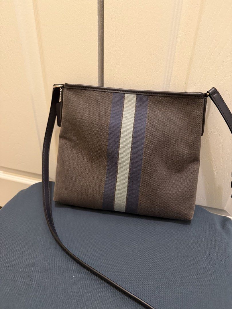 Coach Striped Crossbody File Bag (Category: Cross-body Bags) located in Tabuk. Submitted by farawayluxe (Listing ID 1468006516, Image 2). Description: Gently worn COACH File Bag 100% Authentic Brand: Coach - Material: Brown fabric with dark leather trim - Design: Vertical blue and light green stripes with gold Coach logo - Closure: Secure zip-top closure - Compartments: Fabric-lined interior with Coach creed patch and exterior front pocket - Stra